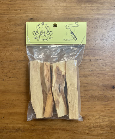 Palo Santo sticks in a clear bag with a green label on a black background