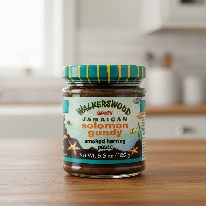 Jar of Walkerswood Spicy Jamaican Solomon Gundy smoked herring paste with a colorful lid on a white background