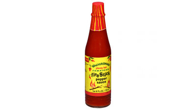 Bottle of Fire Stick pepper sauce with a red cap on a white background
