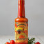 Bottle of Walkerswood Jonkanoo Pepper Sauce with colorful label on a white background